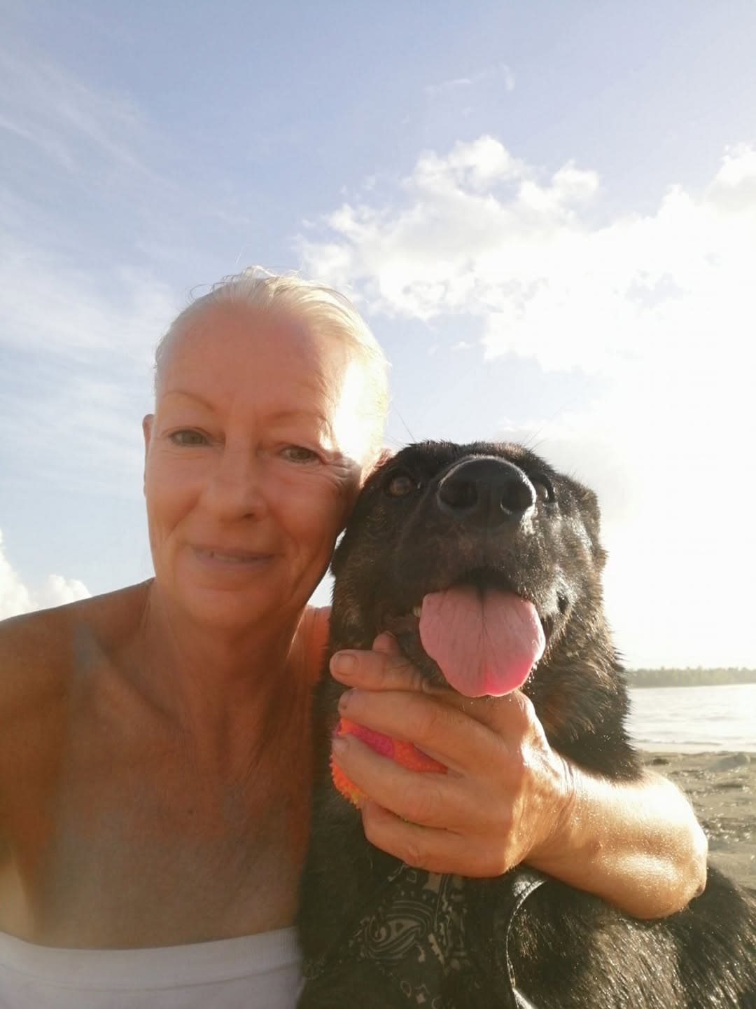 Silvia on the beach with one of the dogs